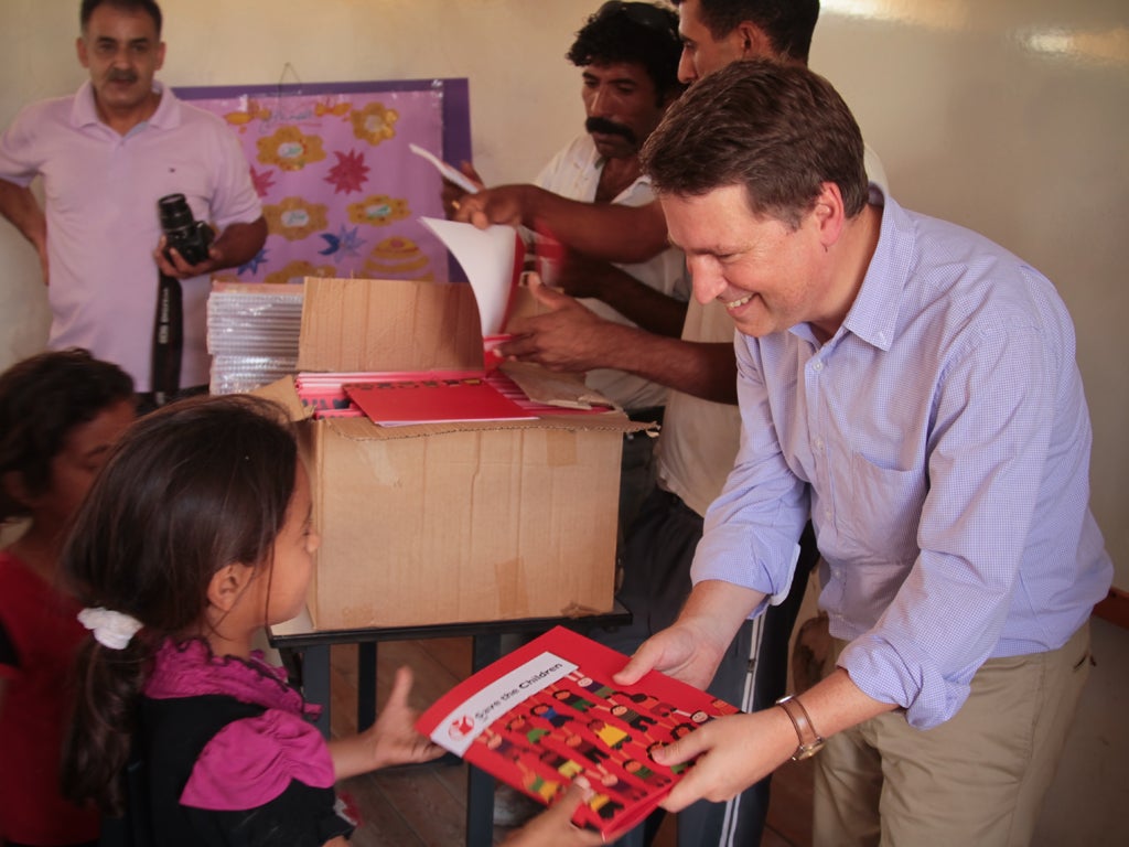 Justin Forsyth, Save the Children’s chief executive, hands
over school supplies in the West Bank