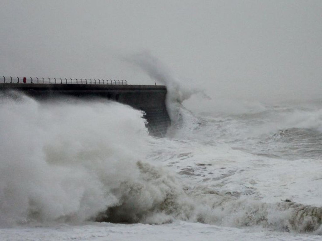 Waves crash over the harbour wall in Dover, Kent, as fierce storms battered Britain today