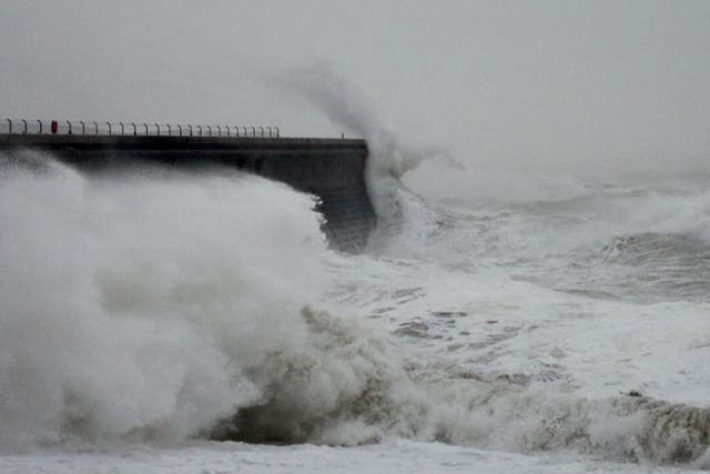 Waves crash over the harbour wall in Dover, Kent, as fierce storms battered Britain today