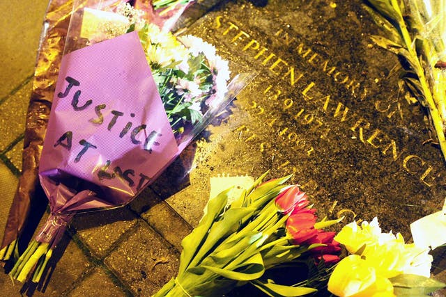 Flowers are left on the memorial plaque to Stephen Lawrence at the bus stop in Eltham, south-east London, where he died