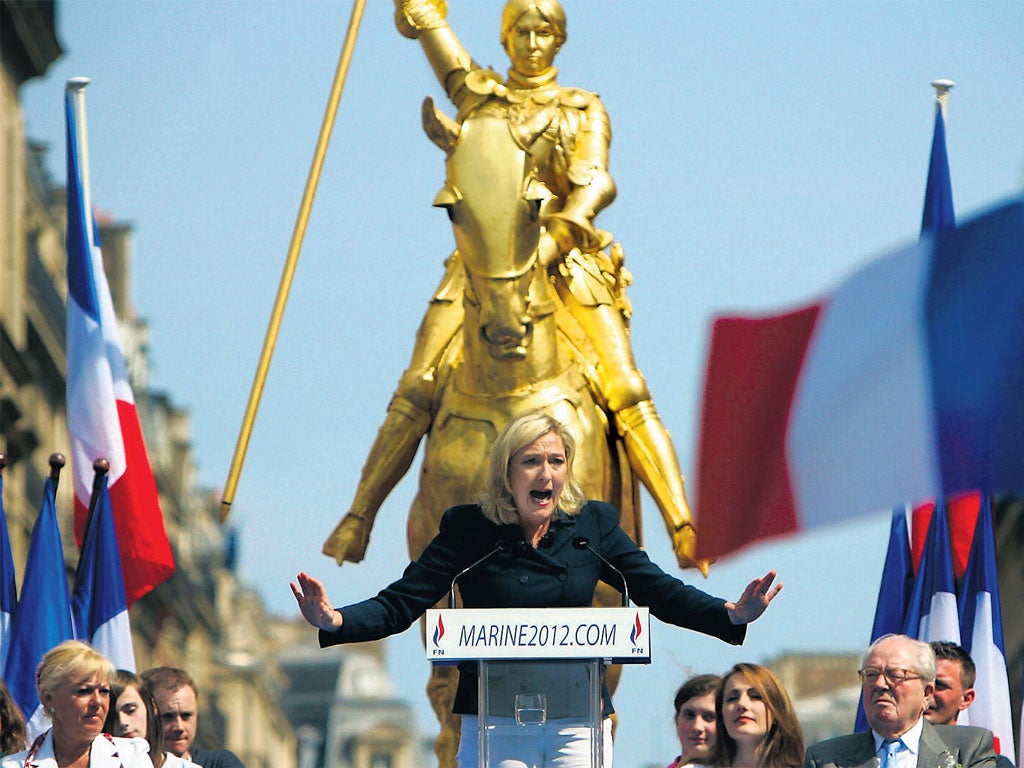 National Front President Marine Le Pen speaks in
front of a statue of Joan of Arc in Paris