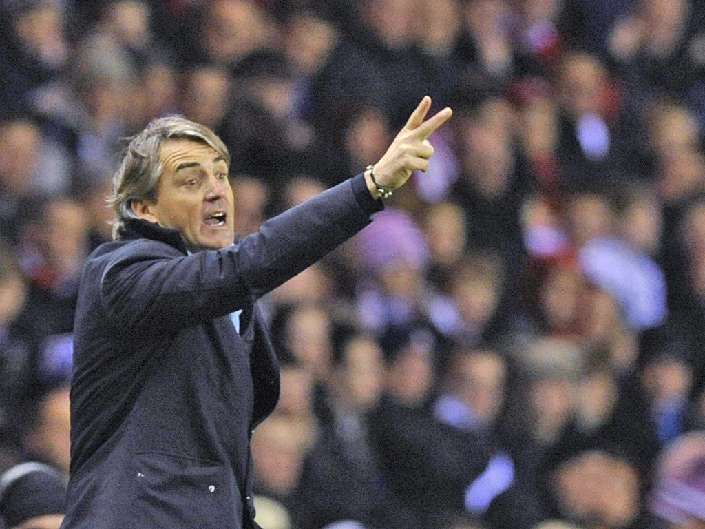 Mancini insisted that City would be under far greater pressure than United in the next four months and must spend to win the title