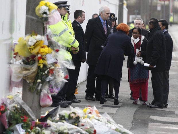 Subhash (second right) and Yogini Bidve visit the spot where Anuj Bidve was killed in Salford