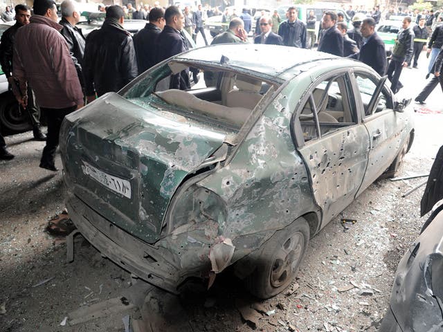 A car damaged after an explosion in the Maidan district of Damascus
