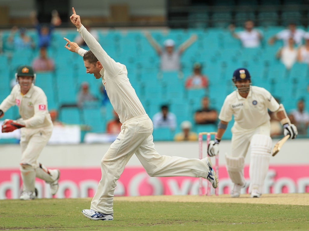 Michael Clarke celebrates the wicket of Sachin Tendulkar (right)
