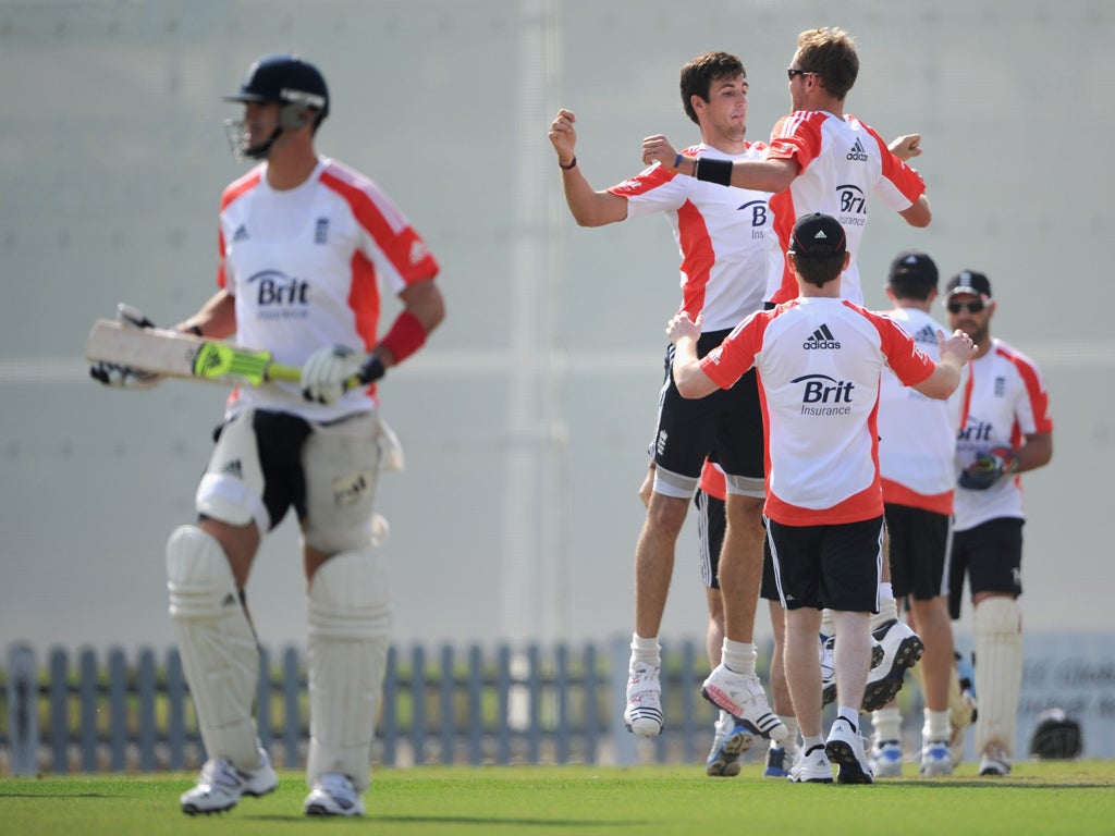 Steve Finn and Stuart Broad celebrate Kevin Pietersen's wicket during a lively practice session in Dubai