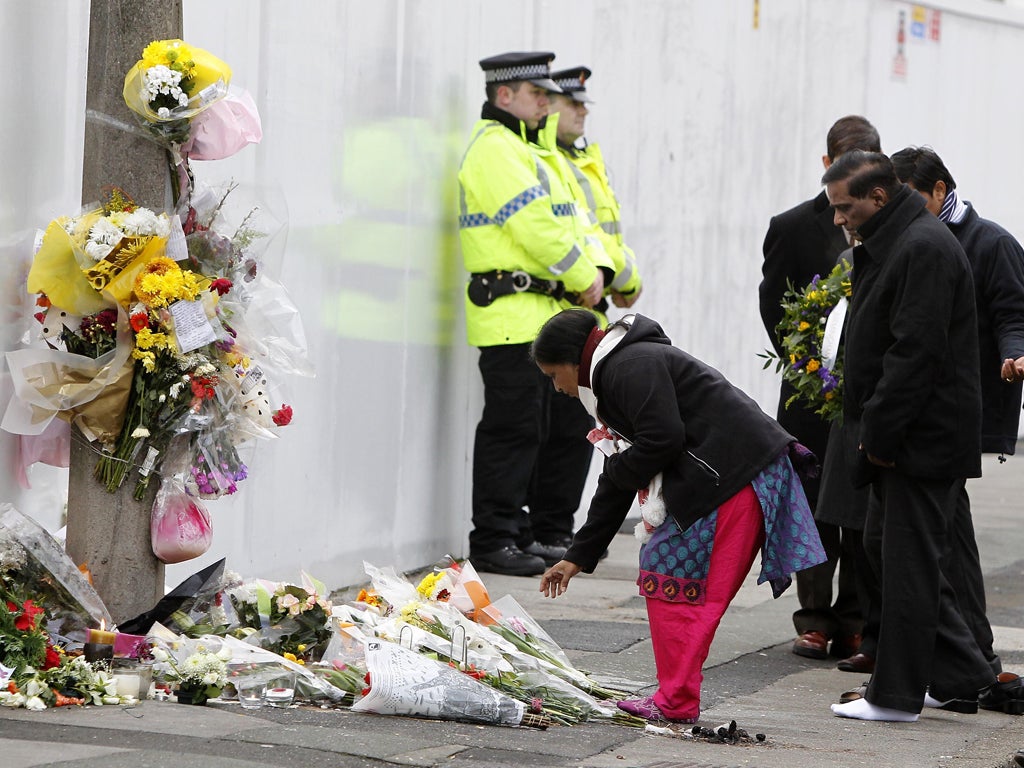 Yogini Bidve lays flowers at the scene of her son's murder in Salford