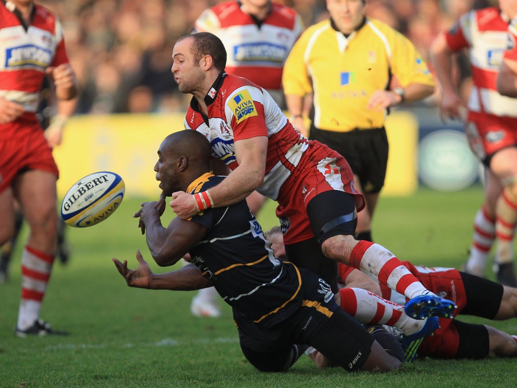 The Gloucester wing Charlie Sharples tackles fellow wide boy - Worcester's Miles Benjamin - at Sixways