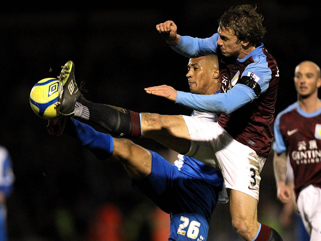 Aston Villa's Stephen Warnock (right) and Bristol Rovers' Chris Zebroski battle for the ball during a routine win for the Villans