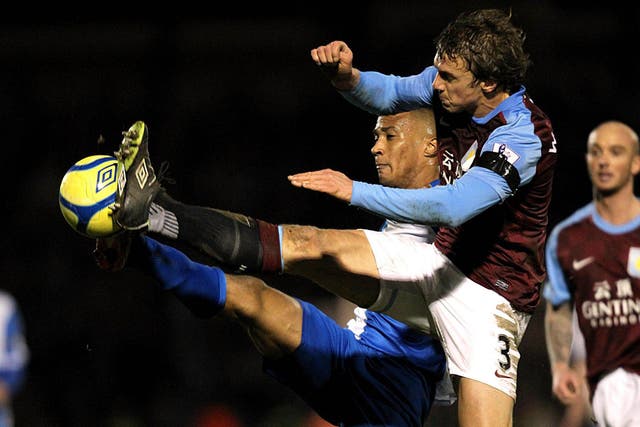 Aston Villa's Stephen Warnock (right) and Bristol Rovers' Chris Zebroski battle for the ball during a routine win for the Villans