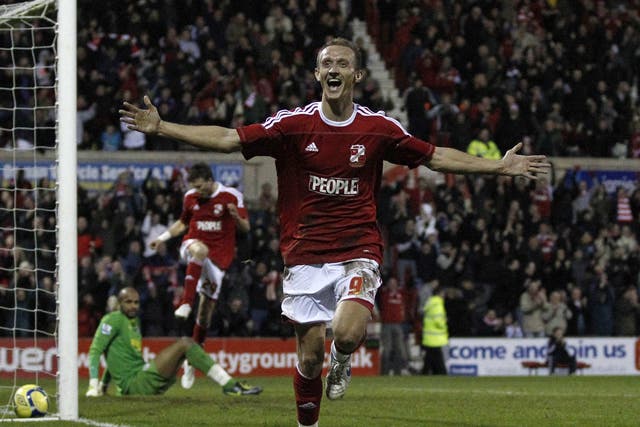 Swindon's Paul Benson celebrates his goal which knocked Wigan Athletic out of the FA Cup at the County Ground yesterday