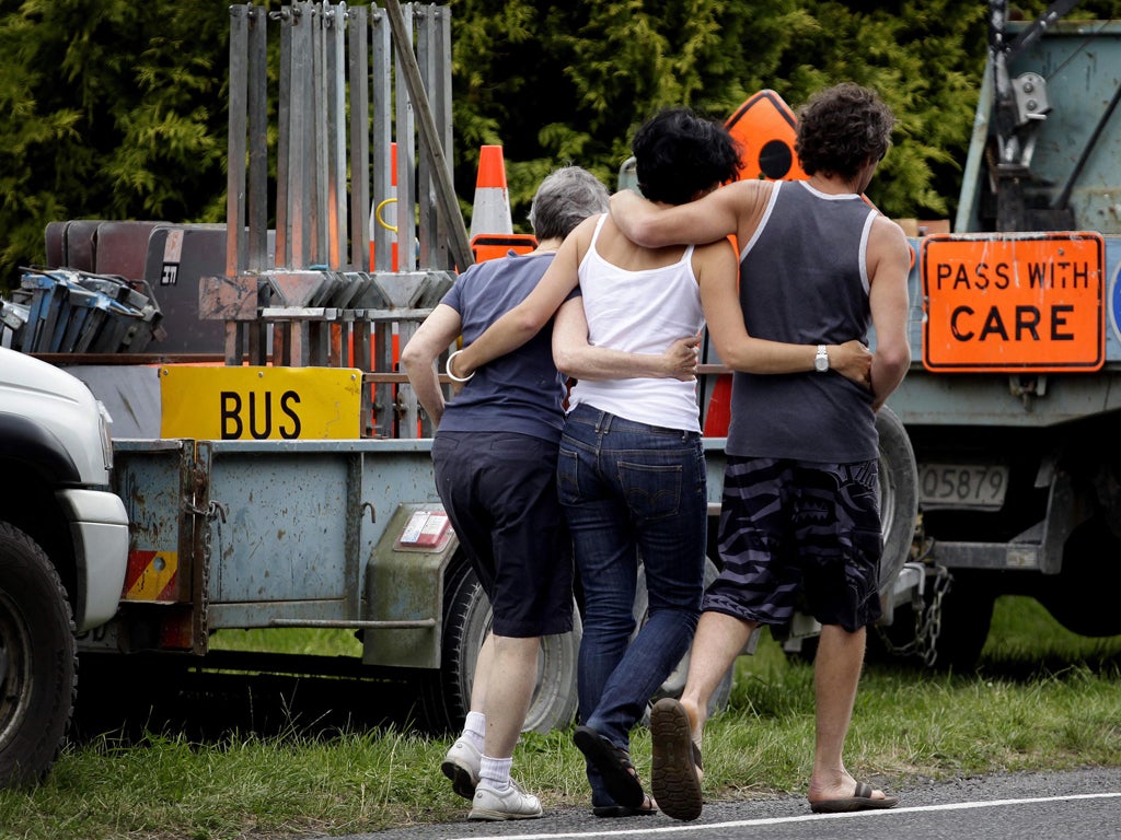 Relatives grieve near the crash site