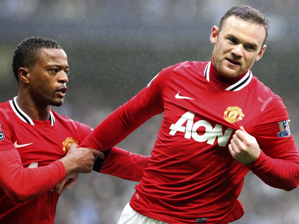 Wayne Rooney celebrates his first goal with Patrice Evra yesterday