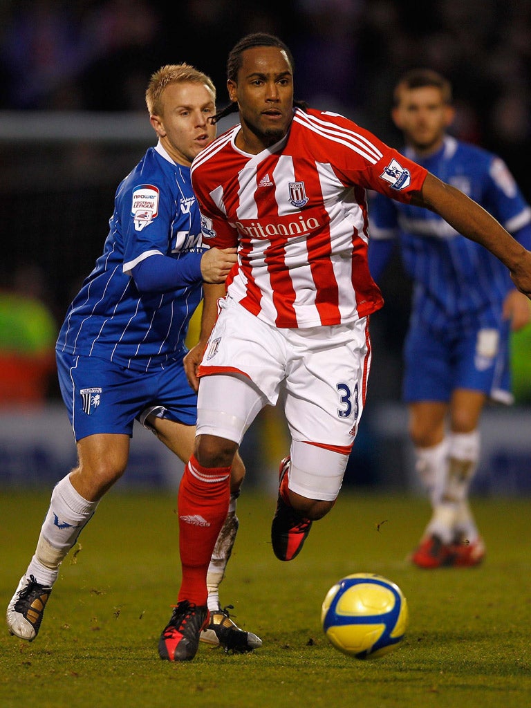 Cameron Jerome, of Stoke, is held back by Gillingham’s Danny Jackman on Saturday