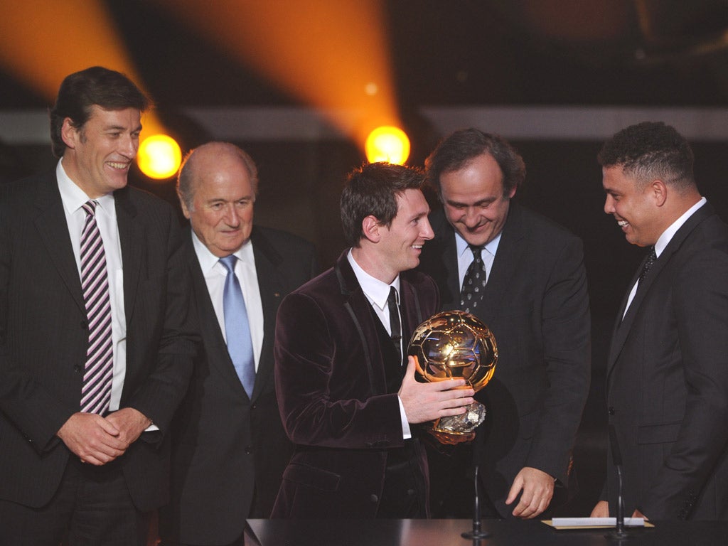 Lionel Messi receives the Ballon d’Or from Uefa president Michel Platini (centre) and former Brazilian player Ronaldo