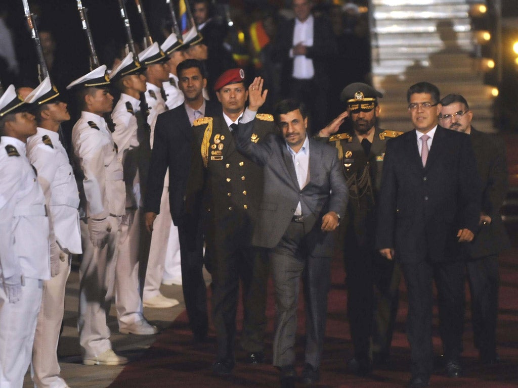 President Mahmoud Ahmadinejad shrugs off the controversy as he arrives in Venezuela