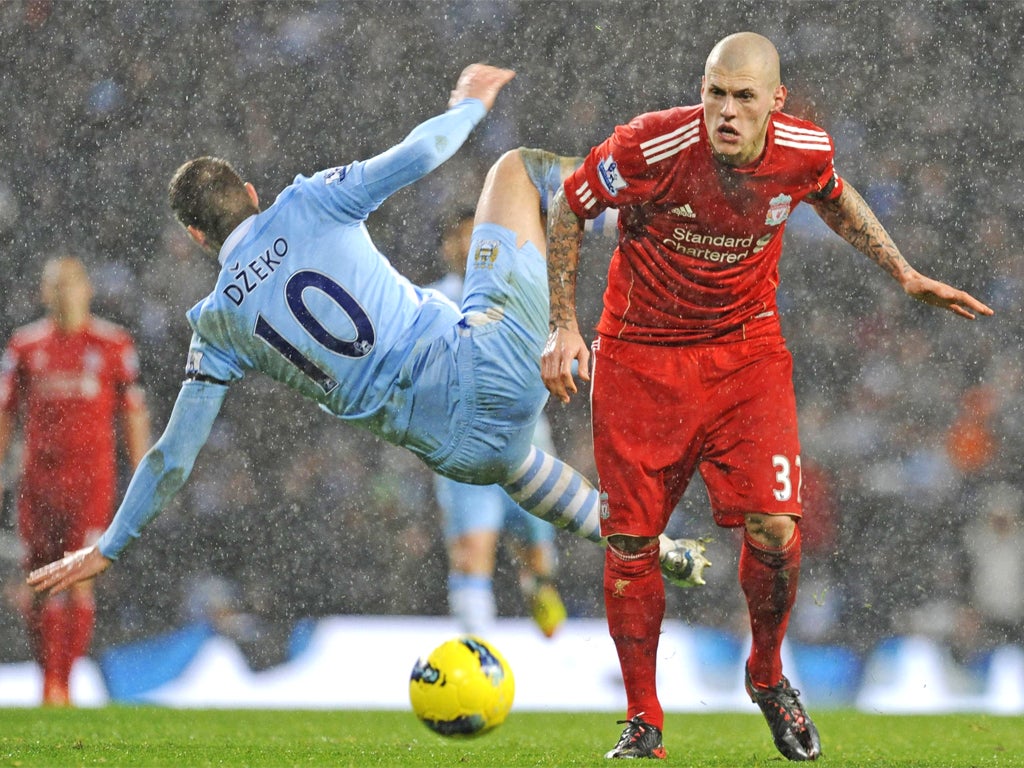 Martin Skrtel fouls Edin Dzeko at the Etihad last week when he gave away a penalty and was troubled by Sergio Aguero