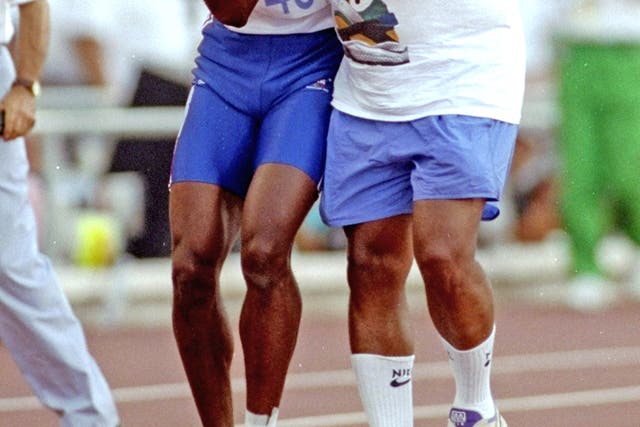 Jim Redmond helps his injured son Derek cross the line in the 400m semi-final at the Barcelona Olympics in 1992