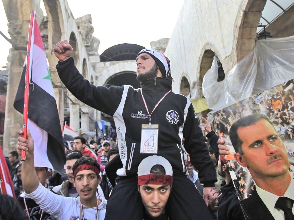 Supporters of President Assad at a rally in Damascus yesterday