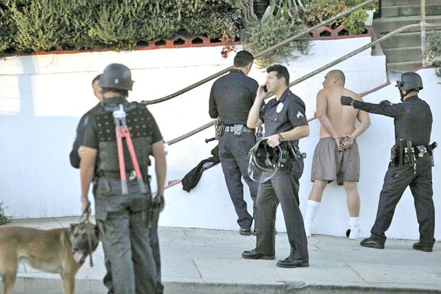 Los Angeles police officers arrest a man after a shooting