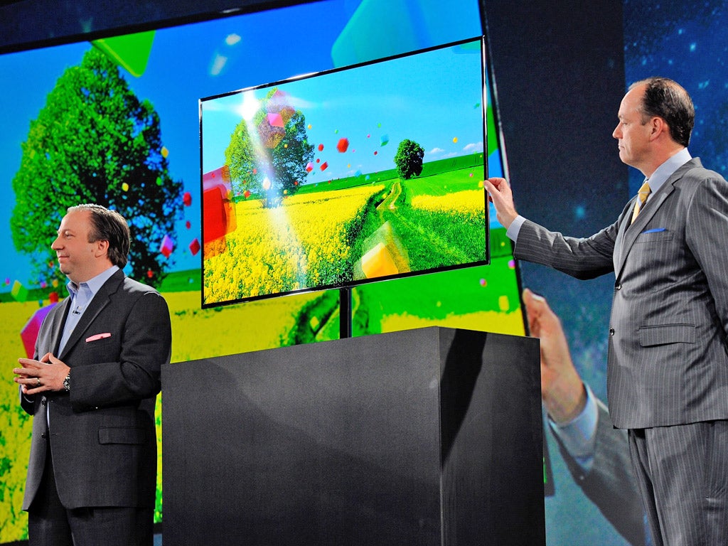 Remote leader: Samsung executives launch their new OLED TV at CES on Monday. But will it stand up to competition from Apple?