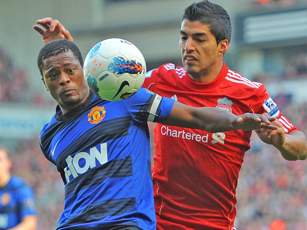 Patrice Evra and Luis Suarez battle for the ball during the October fixture