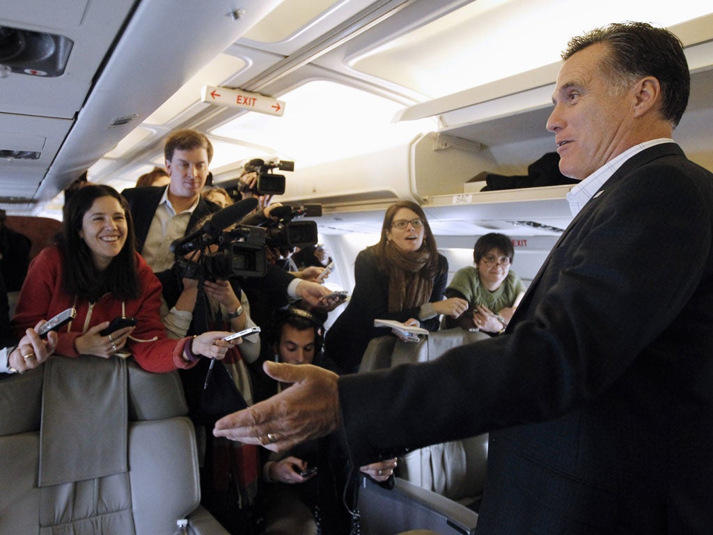 Mitt Romney talks to reporters on his campaign charter plane yesterday