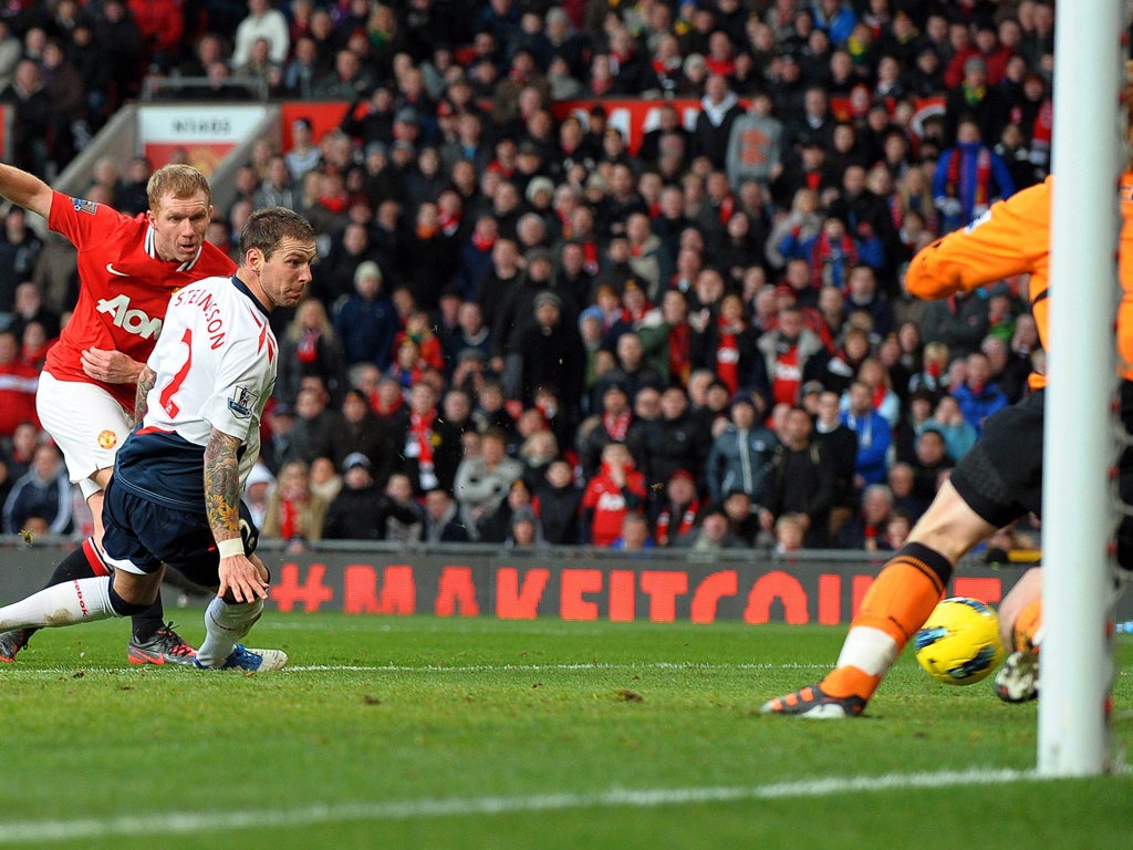 Gretar Steinsson and Bolton goalkeeper Adam Bogdan are powerless to prevent Paul Scholes sending United on their way to a 3-0 win - his first goal for United since August 2010