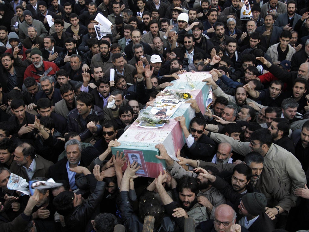 Mourners at Friday's funeral of the nuclear scientist Mostafa Ahmadi Roshan, who was killed on Wednesday when two bombs were placed on his car