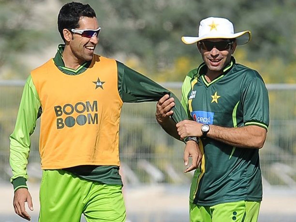 Pakistan captain Misbah-ul-Haq (right) jokes with team-mate Umar Gul during practice in Dubai yesterday