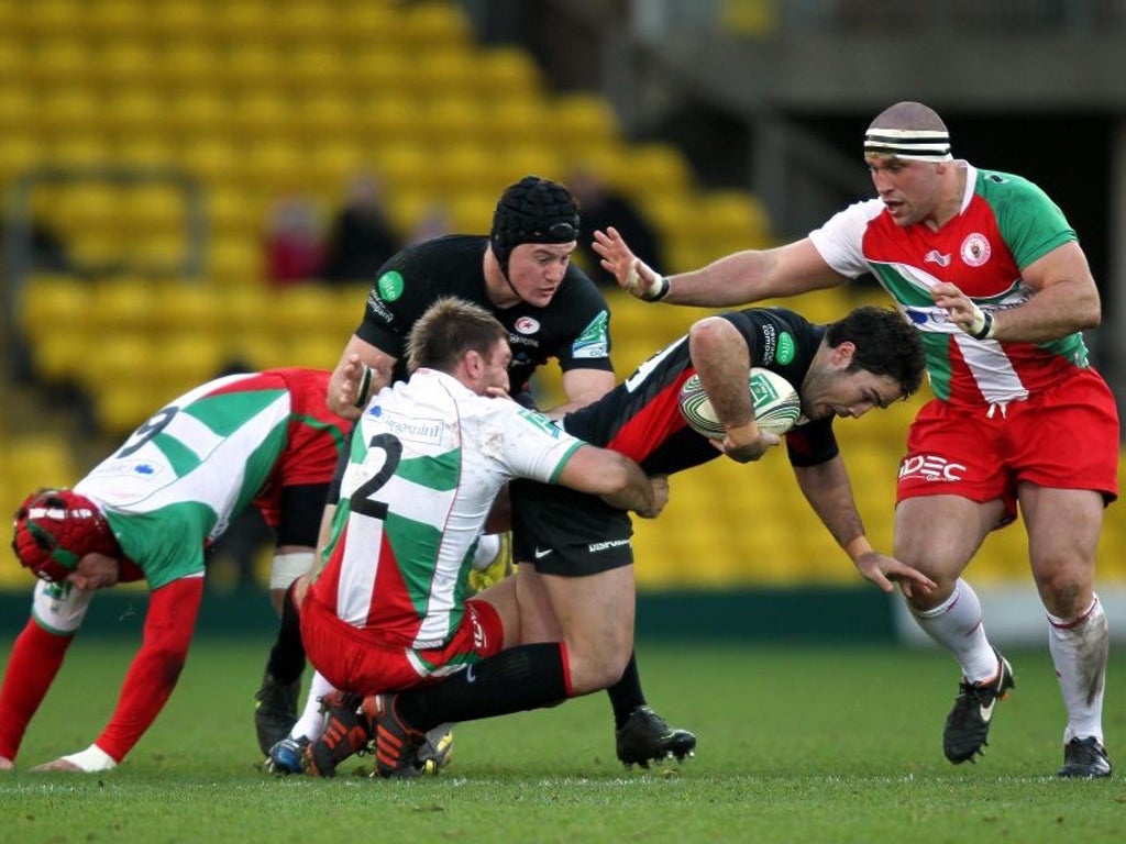 Saracens' Brad Barritt is stopped in his tracks by Biarritz at Vicarage Road yesterday