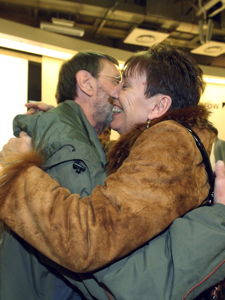 A survivor, Brian Page, is hugged by his sister Christine Clifford as
he arrives safely at Heathrow