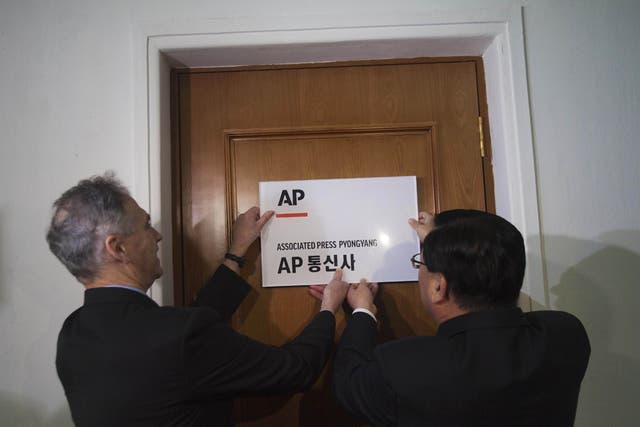 AP President Tom Curley, left, opens the new Pyongyang bureau