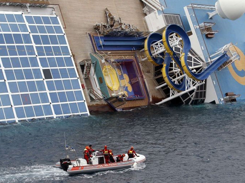 Rescue workers inspect the Costa Concordia