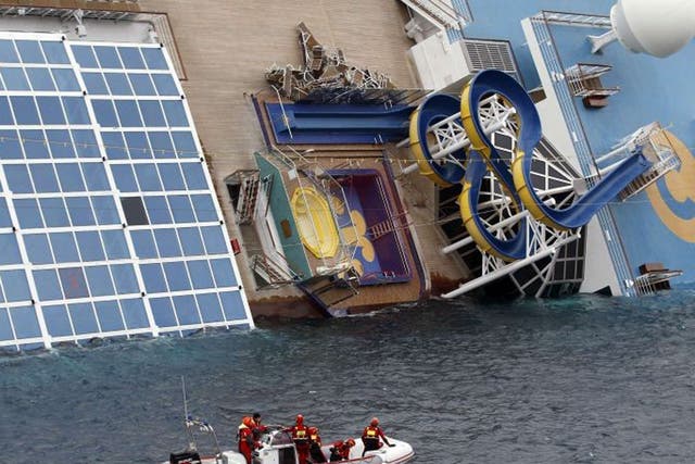 Rescue workers inspect the Costa Concordia