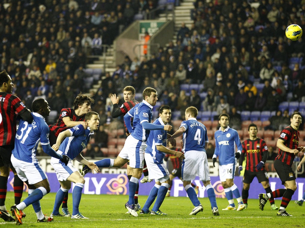 City striker Edin Dzeko (centre) rises up to head in the only goal of the game last night