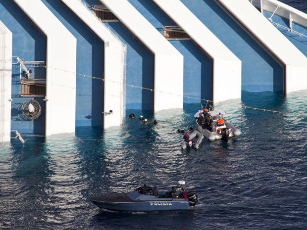 Rescue workers continue operations around and on the sticken cruise ship