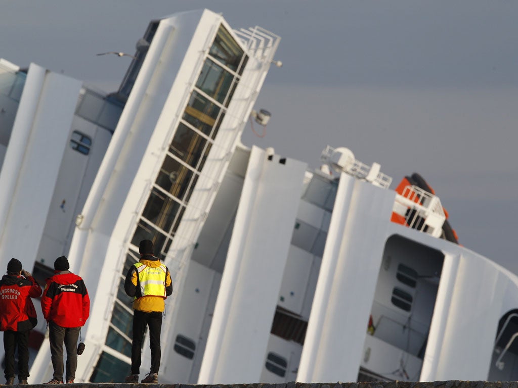 Search teams have suspended operations after the Costa Concordia shifted in turbulent seas