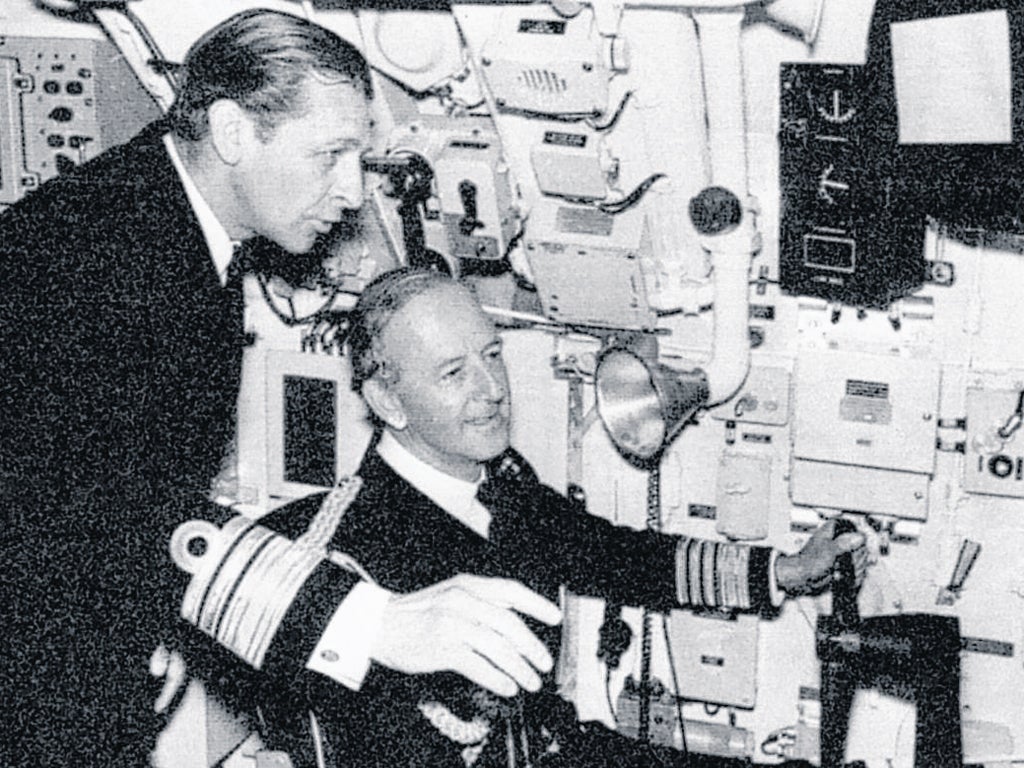 Raikes, left, shows the First Sea Lord, Admiral Sir Edward Ashmore, the controls of HMS ‘Sovereign’ in 1974