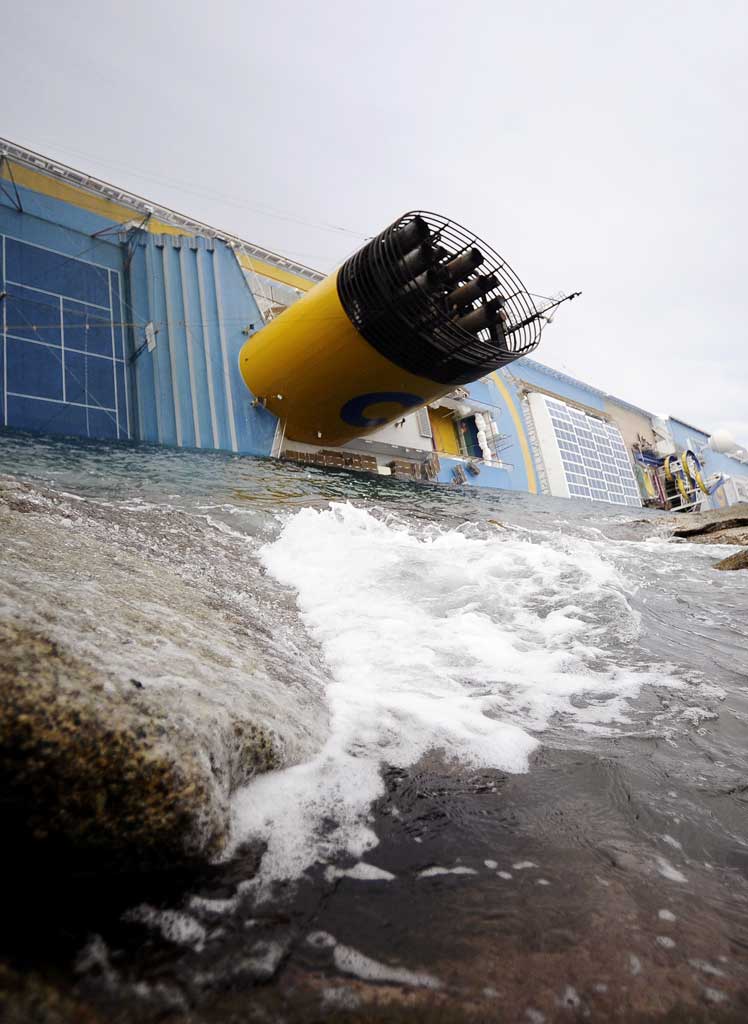 The Costa Concordia cruise ship lies on its side after running aground off the coast of the Tuscan island of Giglio