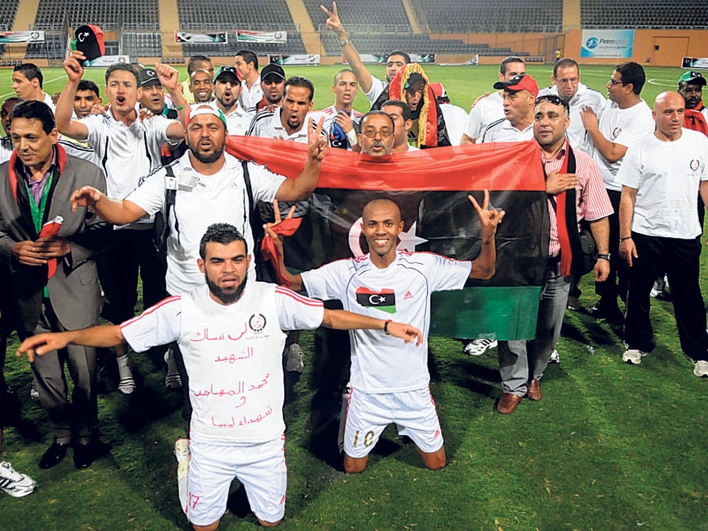 Libya celebrate their qualifying victory over Mozambique, a
game played just a week after the toppling of Muammar
Gaddafi