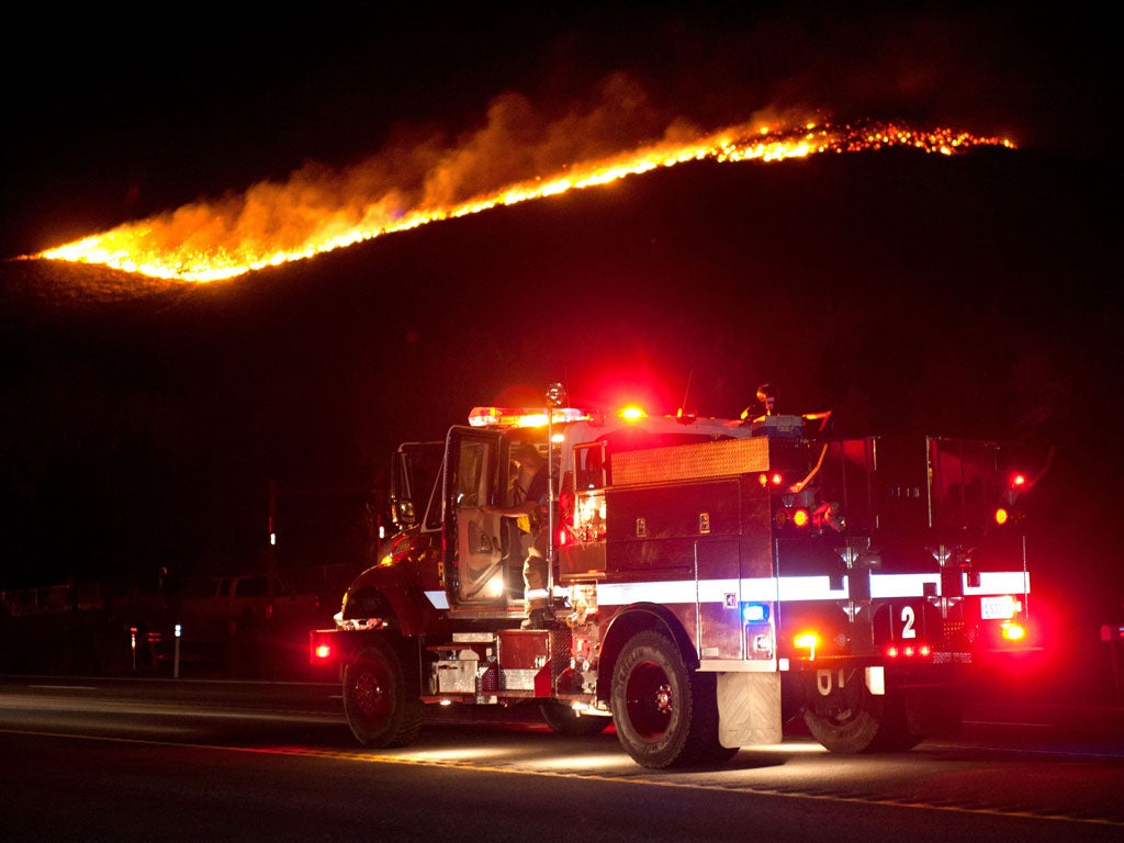 More than 20 homes have been destroyed by a fast-moving brush fire near Reno, Nevada