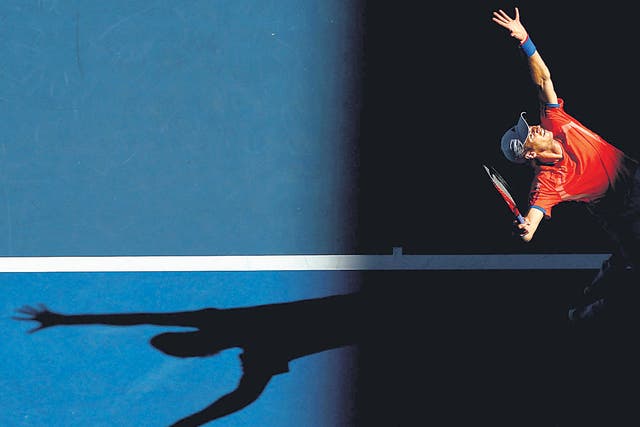 Shadow play: Andy Murray serves on his way to victory over Michaël Llodra in Melbourne