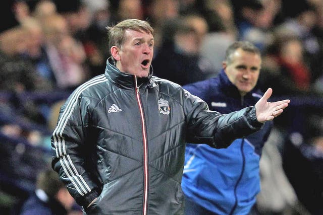 Soundly thrashed: Liverpool manager Kenny Dalglish cuts an unhappy figure on the touchline during last night’s match at the Reebok