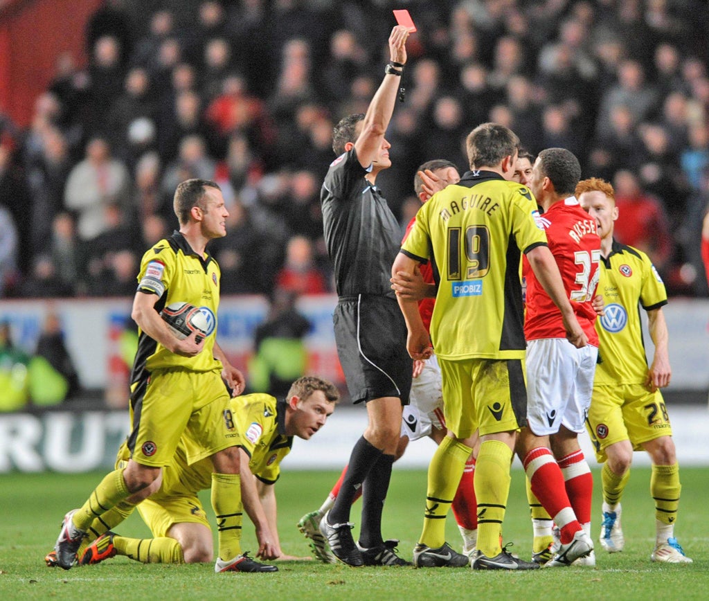 Flash point: Charlton’s Darel Russell is shown a red card for a rash tackle