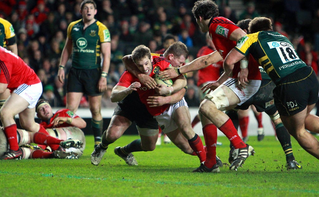 Tomas O’Leary of Munster tests the Northampton
defence in Milton Keynes