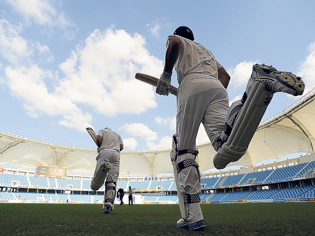 Lonely this winter: England enter a deserted stadium to bat in the First Test against Pakistan in Dubai last week