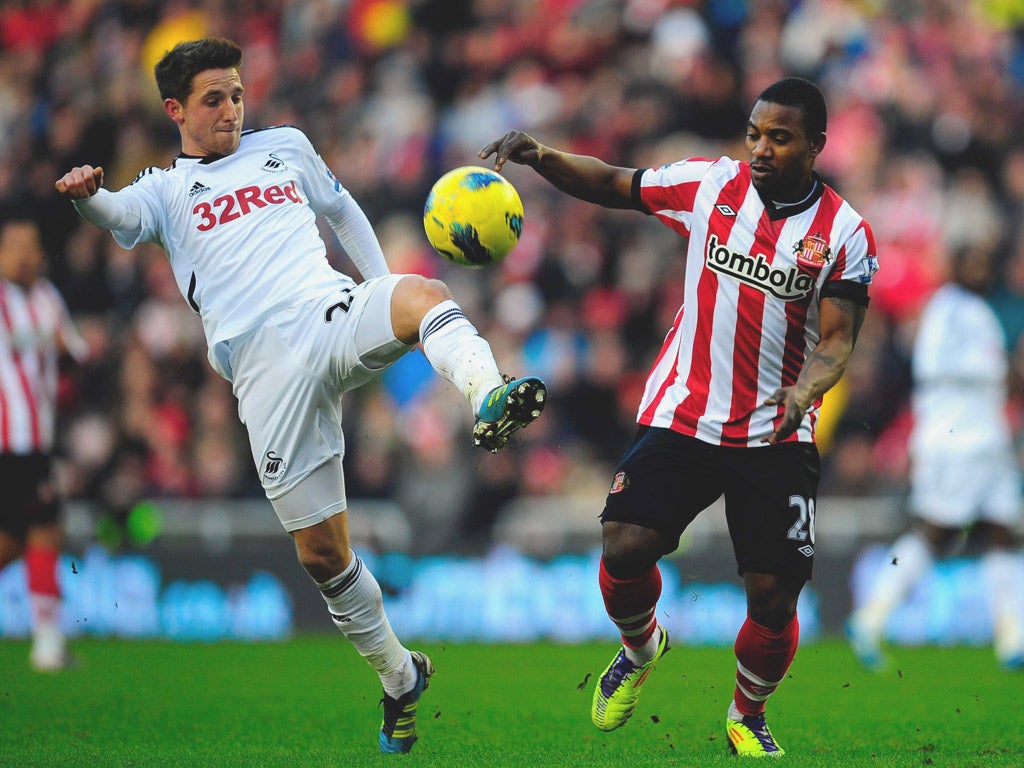Stéphane Sessègnon (right), who scored Sunderland’s first goal and set up their second, is
challenged by Joe Allen, of Swansea