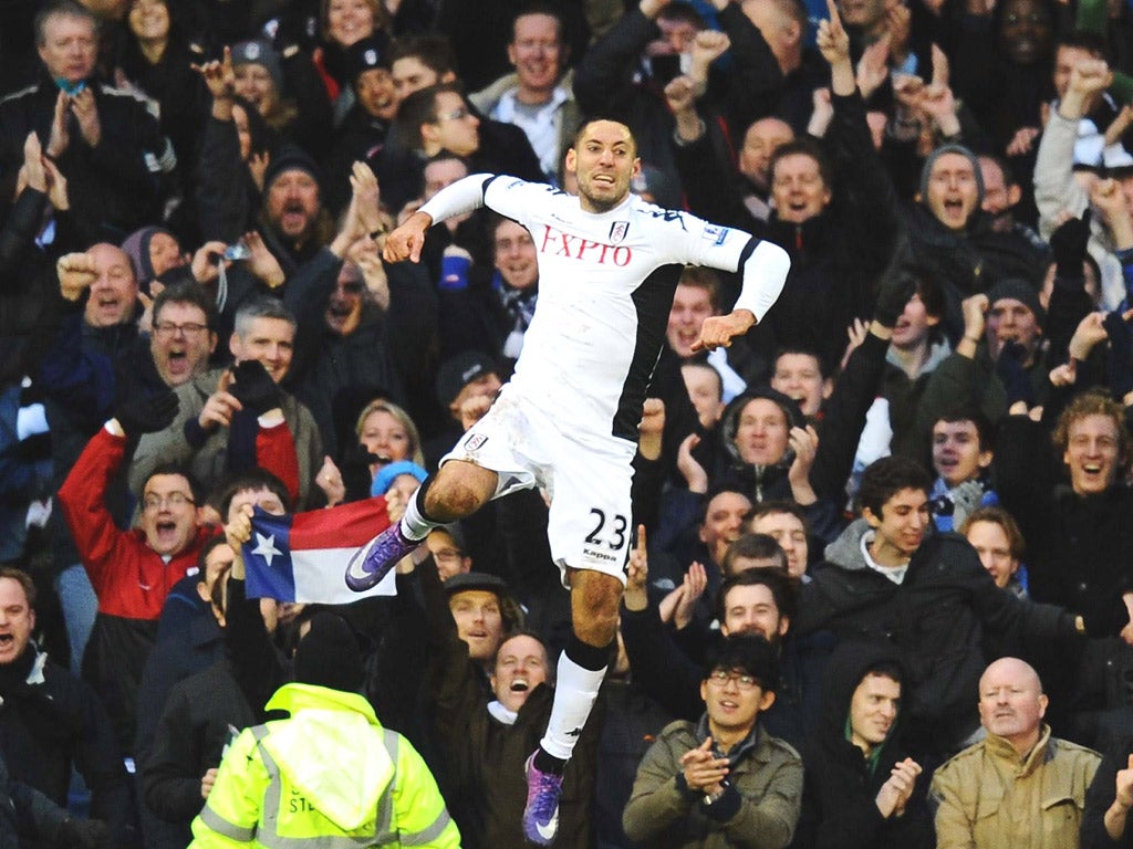 Fulham’s hat-trick hero Clint Dempsey celebrates
during the demolition of Newcastle