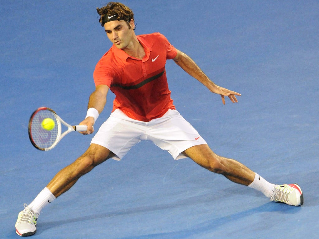 Roger Federer stretches for a shot on his way to victory over Bernard Tomic